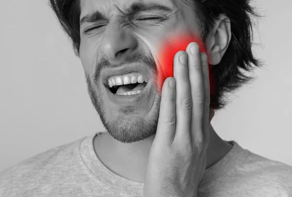 man dealing with jaw pain