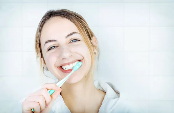 lady brushing her teeth