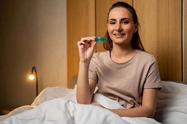 woman holding an oral appliance