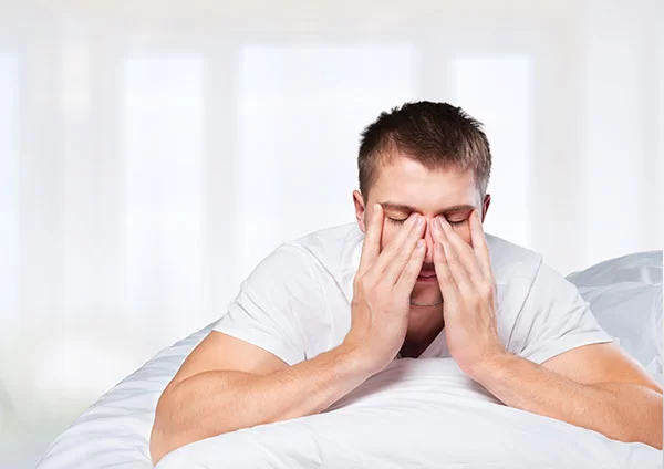 man feeling groggy after a restless sleep